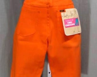 May include: Bright orange high-waisted shorts with a classic five-pocket design. The shorts have a Lee label on the back pocket and a tag that reads "Cool Concepts". The shorts are displayed on a mannequin.