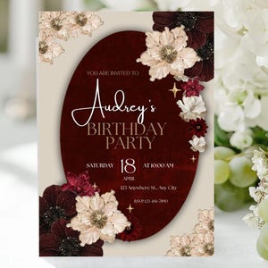May include: A birthday party invitation with a burgundy oval centerpiece. The invitation features the text "Audrey's BIRTHDAY PARTY" in elegant script. Floral accents in cream, burgundy, and red surround the text. The date is Saturday, April 18th, at 10:00 AM.