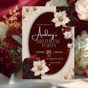 May include: A birthday party invitation with a burgundy oval design, adorned with cream and burgundy floral accents. The invitation reads "Audrey's BIRTHDAY PARTY" with the date, time, and location details. The background features a floral arrangement.