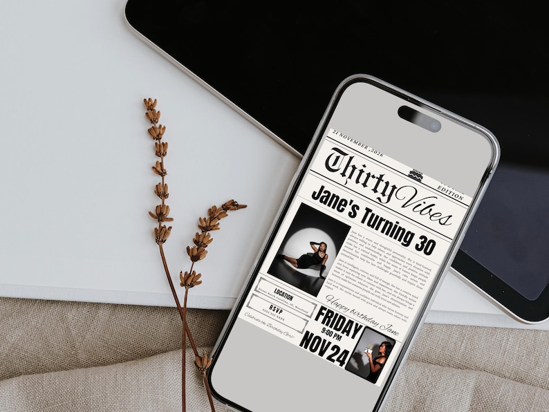 May include: A smartphone displays a birthday invitation with a newspaper theme. The headline reads "Thirty Vibes Jane's Turning 30." The invitation includes a photo, date, time, and location. Dried flowers and a laptop are in the background.