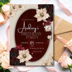 May include: A birthday party invitation with a burgundy oval design, floral accents, and the text "Audrey's BIRTHDAY PARTY" with the date April 18. Includes a kraft envelope and peach roses.