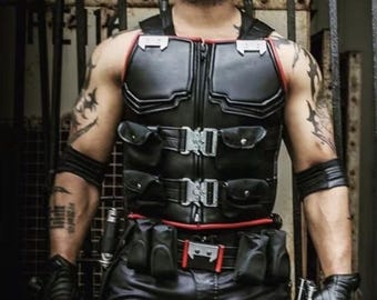 May include: A person wearing a black leather vest with red trim, black leather pants, and fingerless gloves. The person is also wearing red sunglasses and has tattoos on their arms. They are holding a sword and a gun. The image includes the text "BALDGROOVE STUDIOS".