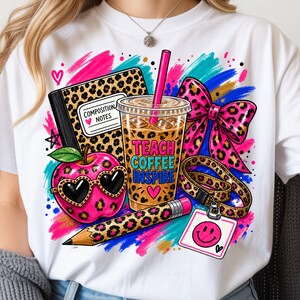 May include: A white t-shirt featuring a colorful graphic of a leopard print composition notebook, a coffee cup with the text TEACH COFFEE INSPIRE, a pink apple with heart sunglasses, a pencil, a leopard print bow, and a smiley face ID badge.