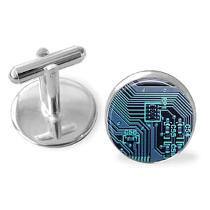May include: Silver cufflinks with a round, blue and green circuit board design.