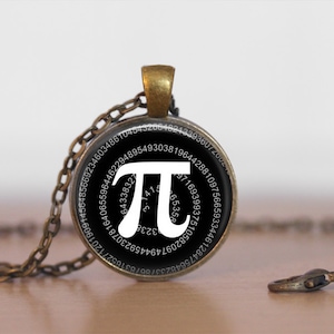 May include: A bronze necklace with a black circular pendant featuring the mathematical constant pi (π) with the first 100 digits of pi displayed around the symbol.