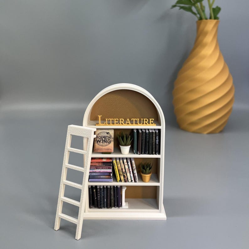 Miniature bookshelf styled with flowers and decorative vase