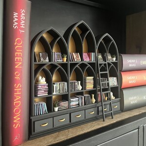 Styled gothic miniature library in dark dollhouse room with warm lighting, books and accessories, 1:12 scale bookcase