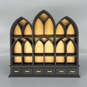Black miniature bookcase set displayed empty on grey background.