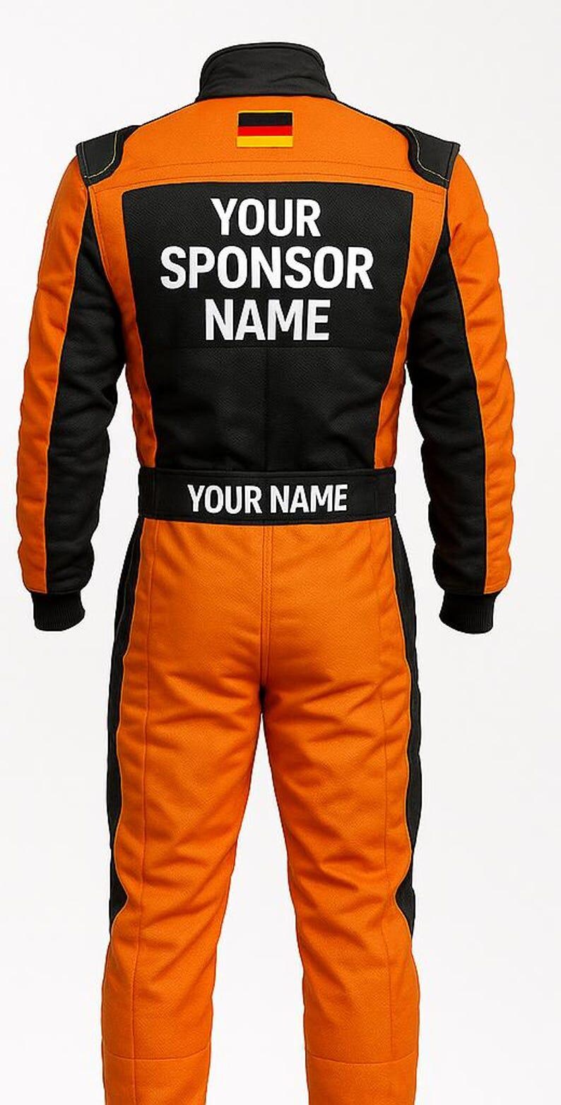 May include: Orange and black racing suit with the text "YOUR SPONSOR NAME" on the back and "YOUR NAME" on the waist. The suit features a German flag patch on the upper back and black accents.