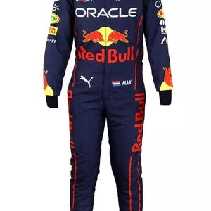 May include: Navy blue racing suit with red and yellow accents. Features the Red Bull logo, sponsor logos, and the name "MAX". Includes the Oracle and Tag Heuer logos. A one-piece garment.