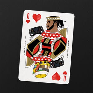 May include: Playing card featuring an illustration of Lewis Hamilton as the Queen of Hearts. The card has a white background with red, black, and gold accents. The text "LEWIS HAMILTON" is printed vertically on both sides.