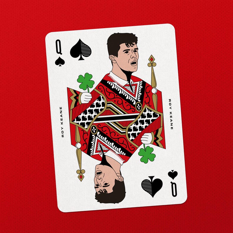 May include: A playing card featuring a stylized illustration of a person as the Queen of Spades. The card has a red and black design with the name "ROY KEANE" printed on it. The background is solid red.