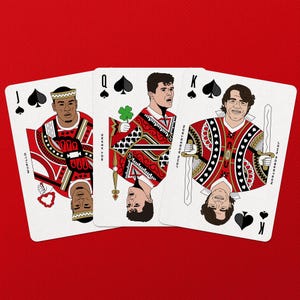 May include: Three playing cards featuring illustrations of people in red and white suits. The cards are the Jack of Spades, Queen of Spades, and King of Spades. The background is a solid red color.