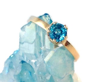14kt. Yellow gold, blue Zircon ring. This ring makes a great stacking, mothers and youths ring. Blue Zircon is a December birthstone.