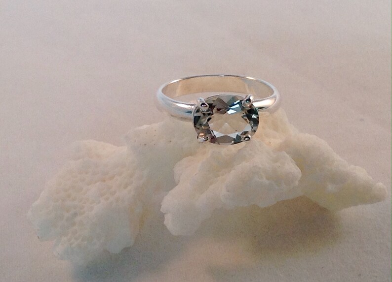 This oval green amethyst stone is set in solid sterling silver and is in a size 6.