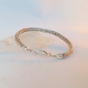 Hand woven bracelet in solid sterling silver.