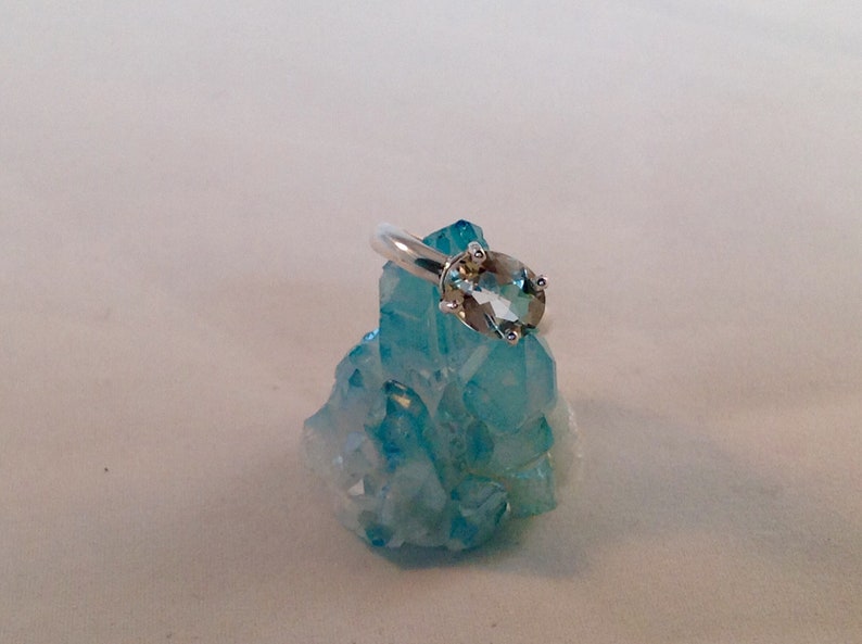 This oval green amethyst stone is set in solid sterling silver and is in a size 6.