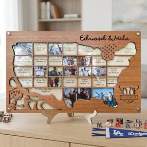 May include: Wooden photo display in the shape of the United States, featuring small photo slots and the text "Edward & Mila." Includes baseball-themed cutouts and the text "MLB Stadium Tour."