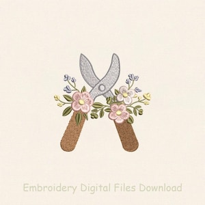 May include: Embroidered design of gardening shears with a floral arrangement. The shears are silver, with brown handles. The flowers are pink, white, and yellow, with green leaves. The text "Embroidery Digital Files Download" is at the bottom.