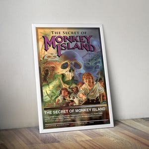 May include: A framed poster titled "The Secret of Monkey Island." The artwork features a skull, pirates, and tropical scenery. Text includes "Graphic Adventure" and "October 15, 1990."