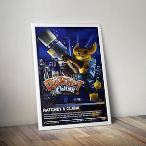 May include: A framed poster featuring the video game "Ratchet & Clank." The artwork showcases the game's characters, Ratchet and Clank, against a futuristic cityscape backdrop. The poster includes the game's title and a brief description.