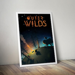May include: A framed poster featuring the words "Outer Wilds" in orange, set against a dark, starry night scene. The artwork depicts a campfire, silhouetted figures, and a spaceship, evoking a sense of adventure and exploration.