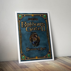 May include: A framed print of the Baldur's Gate II video game cover. The artwork features a teal background with gold accents and the game title in gold lettering. The frame is white.