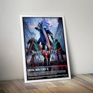 May include: Framed poster for the video game "Devil May Cry 5." The artwork features three figures with swords and a central logo. Text at the bottom reads "DEVIL MAY CRY 5" and "ACTION-ADVENTURE, MARCH 8, 2018."