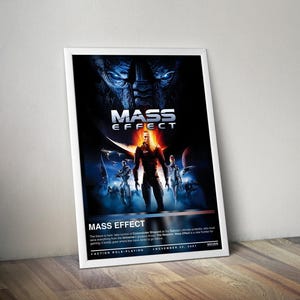 May include: A framed poster for the video game "Mass Effect." The poster features a dark background with the game's title in white and orange. The image includes characters and the text "Action Role-Playing" and "November 20, 2007."