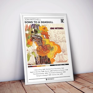 May include: A framed poster for Joni Mitchell's album "Song to a Seagull." The artwork features a colorful, psychedelic design with floral and abstract elements. The album title and artist's name are prominently displayed, along with the tracklist and release date.
