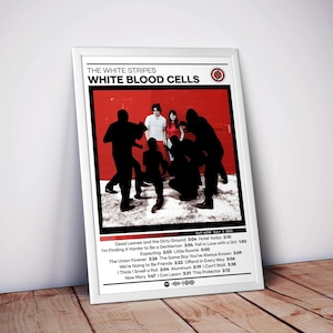 May include: Framed poster for The White Stripes' album "White Blood Cells." The image features a red background with silhouetted figures and band members. The poster includes the album title, band name, and tracklist.
