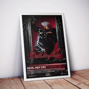 May include: A framed poster for the video game "Devil May Cry." The artwork features a character with white hair holding a large weapon, set against a red and black background. The game's title is prominently displayed in a stylized font.