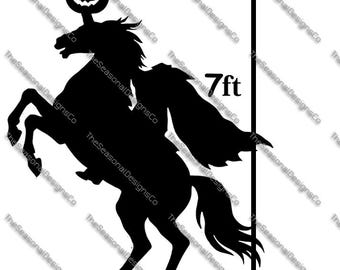 May include: A black metal silhouette of the Headless Horseman riding a rearing horse, with a jack-o'-lantern head. The figure is approximately 7 ft tall. The Seasonal Designs Co. is printed on the image.