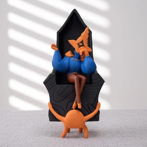 May include: A stylized figurine featuring a central character with an orange star-shaped head, blue long-sleeved top, and brown legs, seated on a tall black throne with wood grain patterns. An orange creature with four limbs sits at the base.