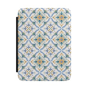 May include: A rectangular case with a decorative floral pattern in shades of blue, gold, and green on a white background. The case has a black spine on the left side. The floral design is symmetrical and detailed.