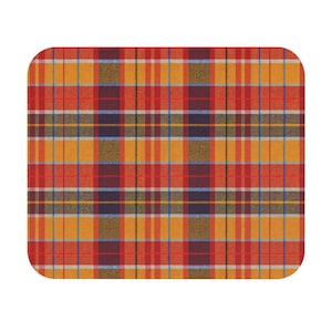 May include: A rectangular plaid pattern in shades of red, orange, yellow, blue, and brown. The design features a classic grid of intersecting vertical and horizontal lines, creating a traditional tartan appearance. The edges of the rectangle are rounded.