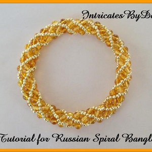 May include: A gold and amber beaded bracelet with a spiral design. The bracelet is made with small seed beads and is a tutorial for a Russian Spiral Bangle.