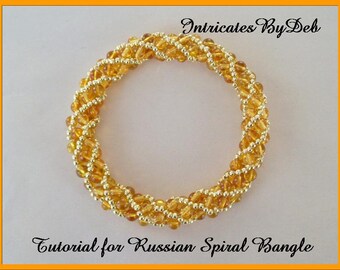 May include: A gold and amber beaded bracelet with a spiral design. The bracelet is made with small seed beads and is a tutorial for a Russian Spiral Bangle.