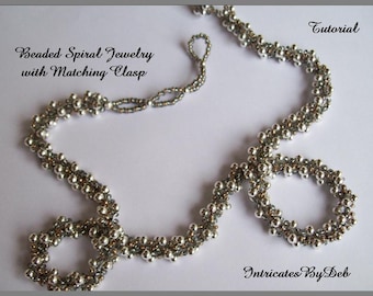May include: A silver beaded spiral necklace with a matching clasp. The necklace is made with small silver beads and is a delicate and elegant piece of jewelry. The image includes the text "Beaded Spiral Jewelry with Matching Clasp" and "Tutorial".