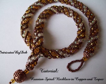May include: A copper and topaz beaded necklace with a spiral design. The necklace is made with small seed beads and features a copper toggle clasp.