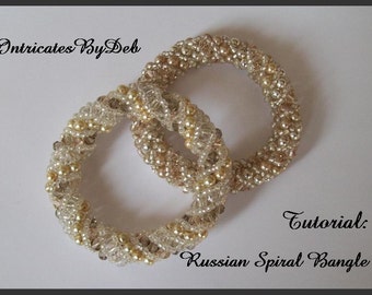 May include: Two gold and clear beaded bracelets in a spiral design. The bracelets are intertwined and the image includes the text "Tutorial: Russian Spiral Bangle".