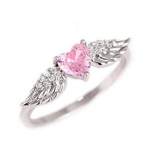 May include: A silver ring featuring a pink heart-shaped gemstone, flanked by detailed wing designs. The wings are embellished with small, clear gemstones. The ring is set against a white background, highlighting the jewelry's delicate features.