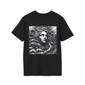 May include: Black t-shirt featuring a grayscale graphic of a woman's face emerging from ocean waves. The artwork has a classical, artistic style, with detailed shading and flowing lines. The design is centered on the shirt.