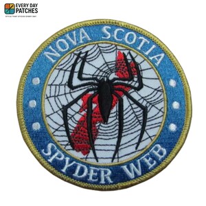 May include: Embroidered patch featuring a black spider on a web, with the words "NOVA SCOTIA SPYDER WEB" in white lettering on a blue and gold circular design. The patch has the text "EVERY DAY PATCHES" at the top.