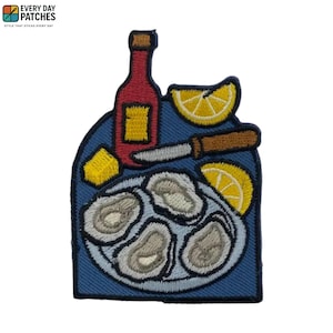 May include: Embroidered patch featuring a plate of oysters, lemon wedges, a bottle of wine, and a knife. The patch has a blue background and the text "EVERY DAY PATCHES" at the top.