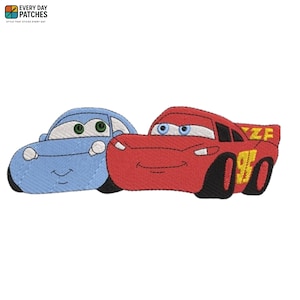 May include: Embroidered patches featuring cartoon cars. One is red with the number 95 and the text "ZF", the other is blue. The patches have smiling faces and are likely for children's apparel or accessories.
