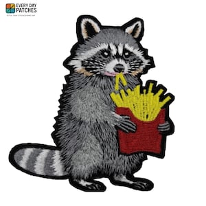 May include: Embroidered patch featuring a raccoon eating french fries from a red carton. The raccoon is gray, white, and black with a pink tongue. The patch has a black border and the text "EVERY DAY PATCHES" at the top.