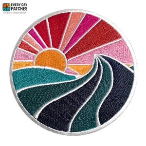 May include: Embroidered patch featuring a colorful sunset over rolling waves. The design includes an orange sun, red and pink rays, and teal, green, and navy blue waves. The patch is round with a white border. The text "EVERY DAY PATCHES" is at the top.