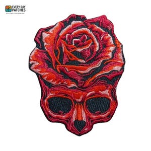May include: Embroidered patch depicting a red skull with a rose. The rose is in shades of red and orange, with detailed stitching. The patch has the text "EVERY DAY PATCHES" and "STYLE THAT STICKS EVERY DAY".