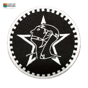 May include: Round black patch with a white star and a profile of two figures. The patch has a white border with a dotted pattern. The text "EVERY DAY PATCHES" is at the top left.